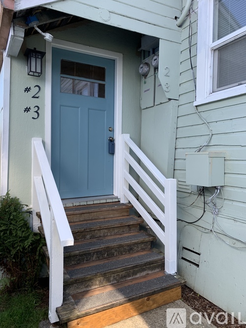 A blue door with the numbers 2 and 3 on the wall above it.