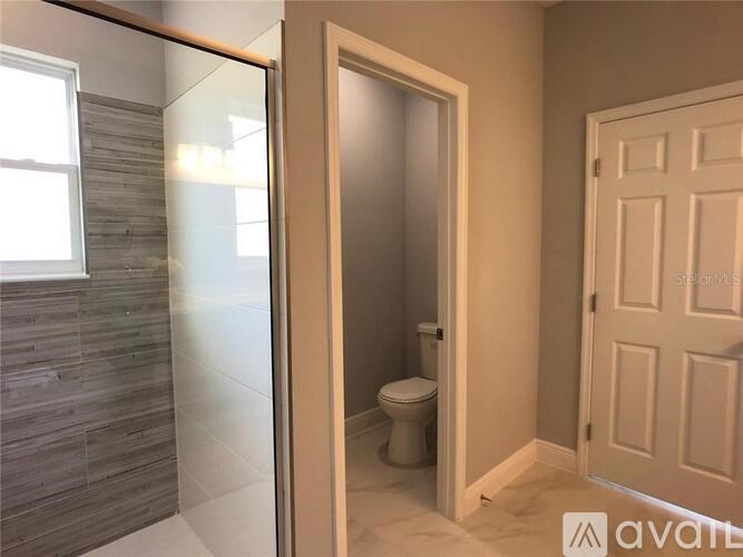 A bathroom with a toilet and a wooden door.