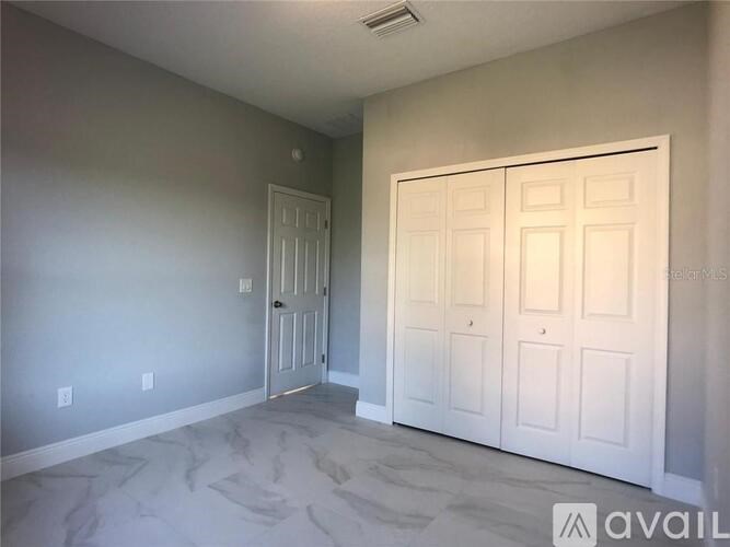 A room with a door and a wall with switches.