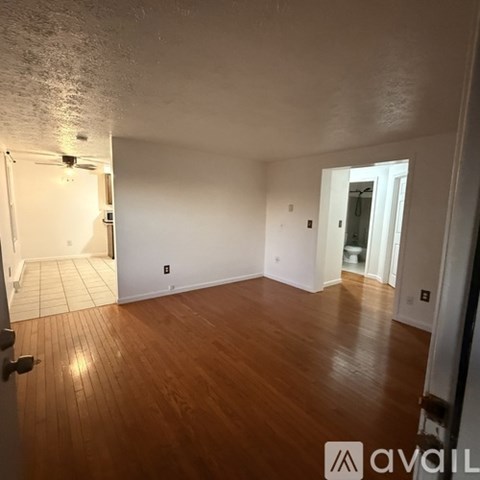 A room with wooden floors and white walls.