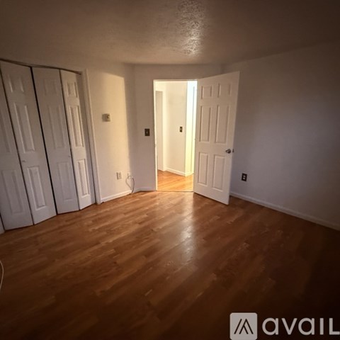 A room with wooden floors and white doors.