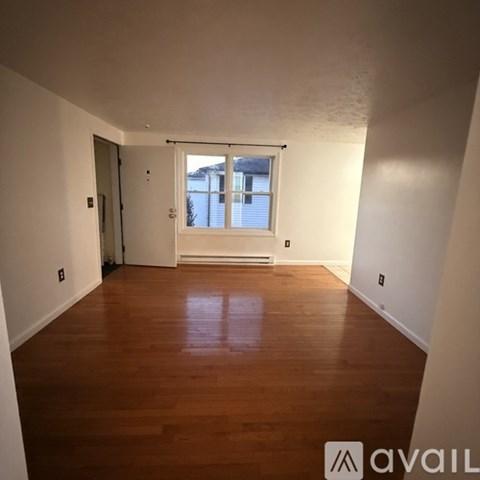 A room with wooden floors and a window.