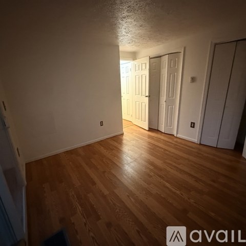 A room with wooden floors and white walls.