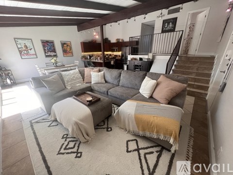 A living room with a grey couch and a coffee table.
