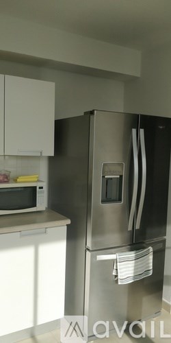 A stainless steel refrigerator with a water dispenser on the door.