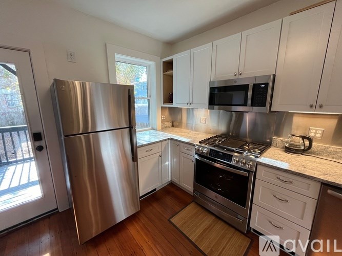 A kitchen with a stainless steel refrigerator and oven.