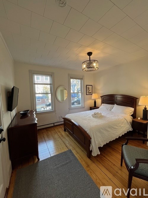 A bedroom with a large bed and a window with a view.