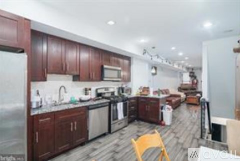 A kitchen with wooden cabinets and a refrigerator.