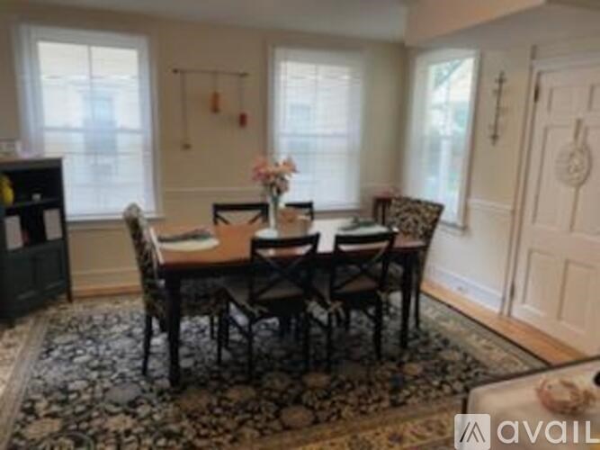 A dining room with a table set for four.