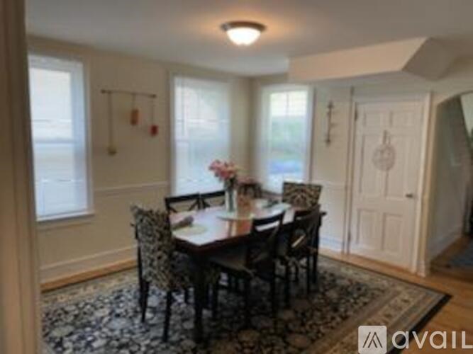 A dining room with a table set for four.
