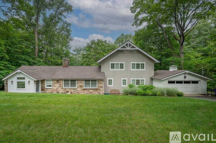 A house with a stone foundation is for sale.
