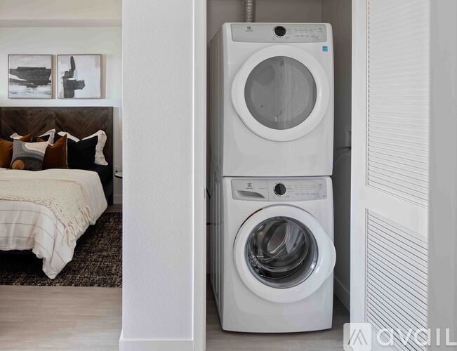 A white washing machine and dryer in a laundry room.