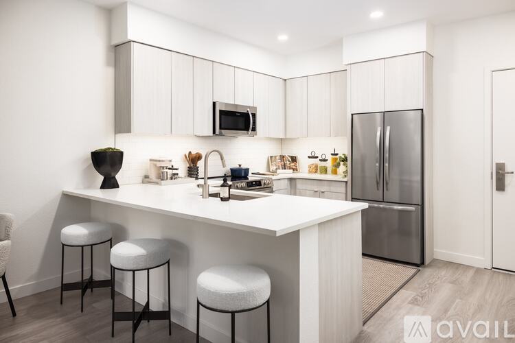 A modern kitchen with white cabinets and a central island.