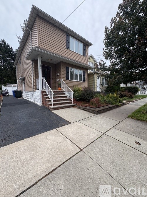 A house with a brown siding and a white door is shown.