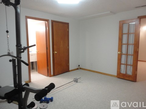 A room with a gym equipment on the left side.