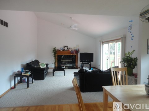 A living room with a fireplace and a TV.