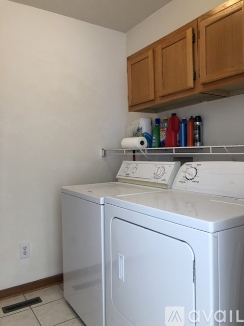 A white washing machine in a laundry room.