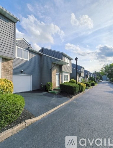 A row of houses with a street in between.