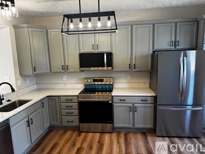 A kitchen with a stove top oven and a refrigerator.