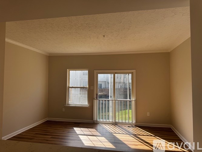 A room with a sliding glass door leading to a balcony.