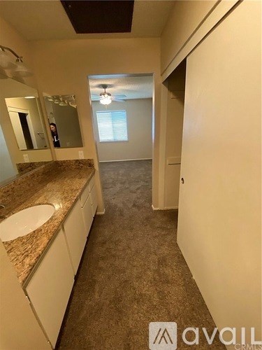 A bathroom with a sink and mirror.