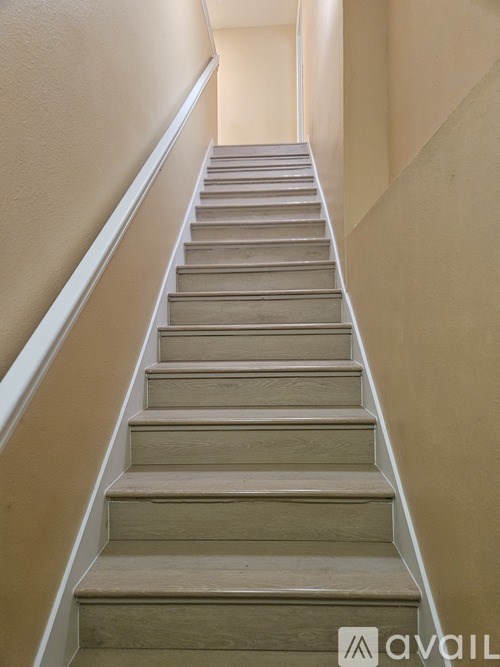 A set of stairs with a white railing.