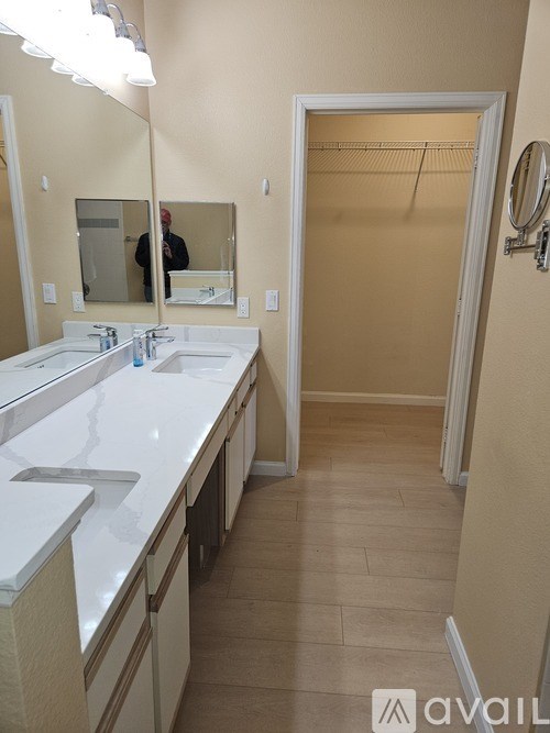 A bathroom with a sink, mirror, and a closed door.