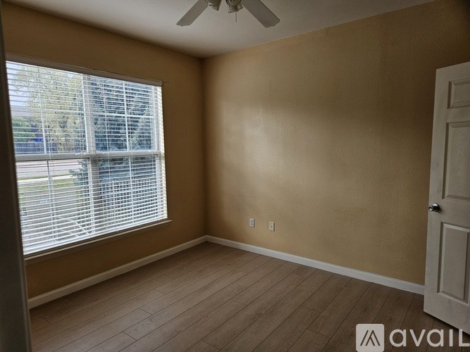 A room with a window and a door.