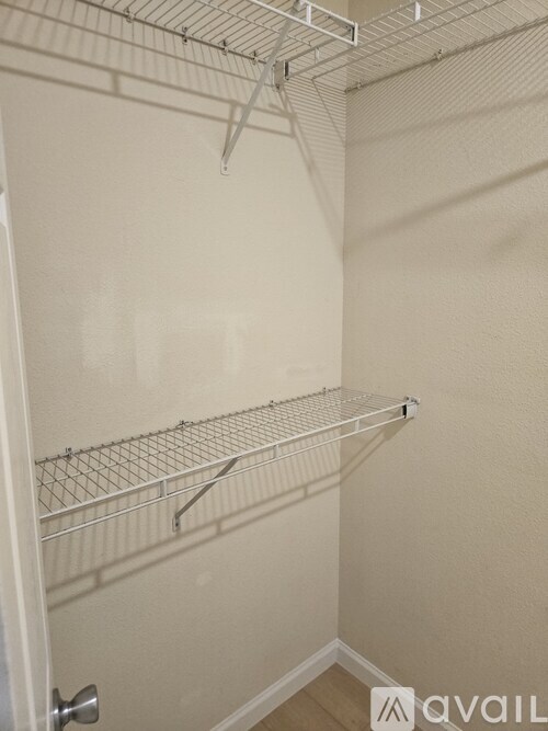 Empty shelves in a white closet.