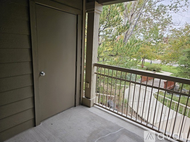 A view from a balcony with a door and a railing.