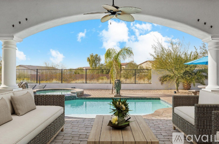 A patio with a pool and a white sofa.
