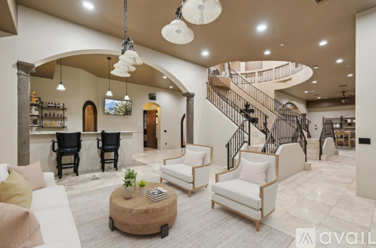 A living room with a spiral staircase and a coffee table.