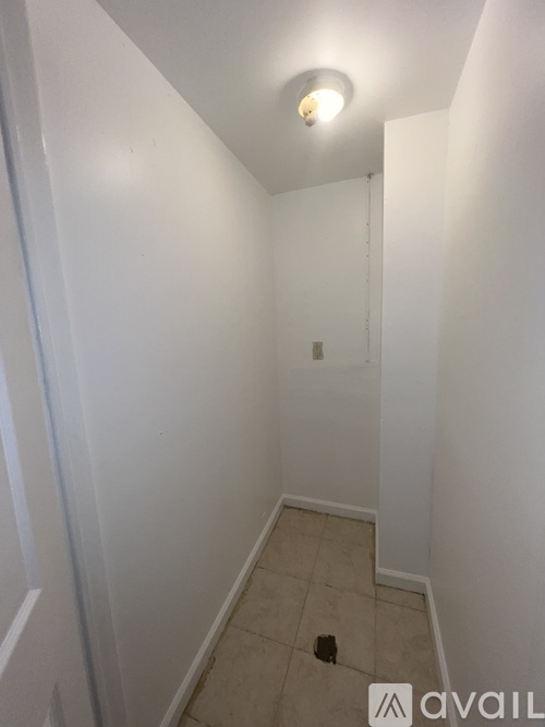 A small, empty room with a light on the ceiling.