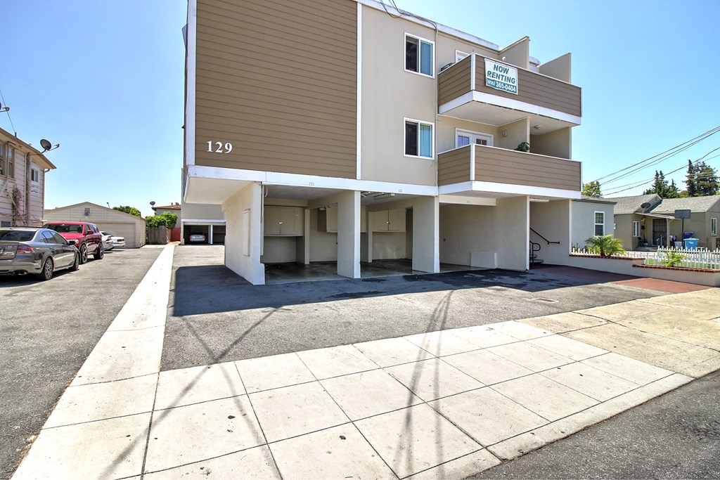 a view of the side of a building with a street in front of it