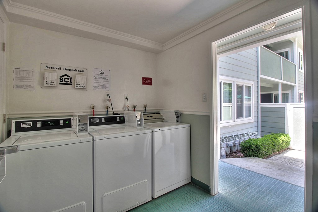 A laundry room with washer and dryer machines.