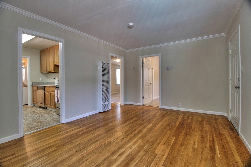 A room with wooden floors and white walls.