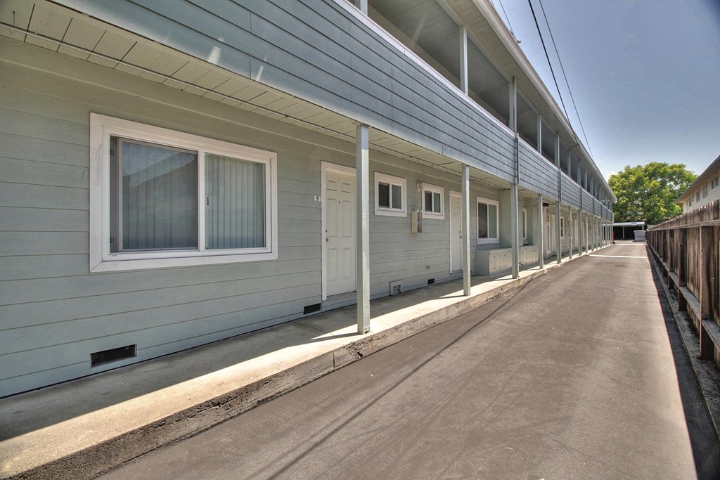 A long row of houses with grey siding and white trim.