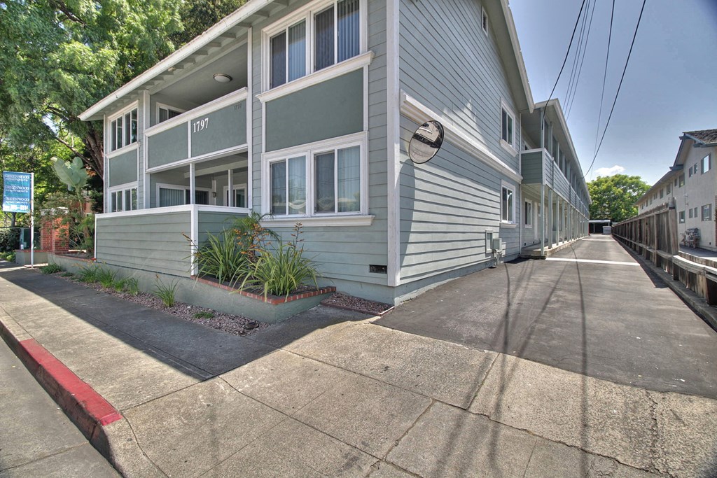 A street view of a residential area with apartment buildings.