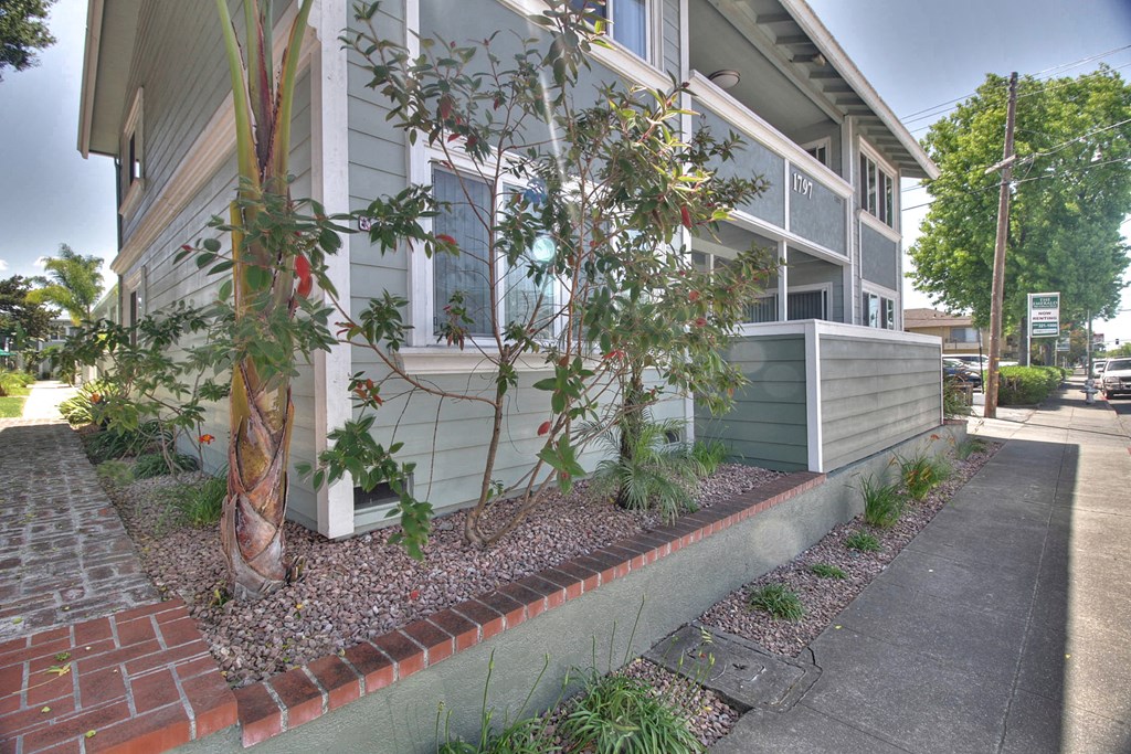 A house with a grey facade and a grey roof with a grey fence.