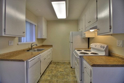 a kitchen with white appliances and granite counter tops