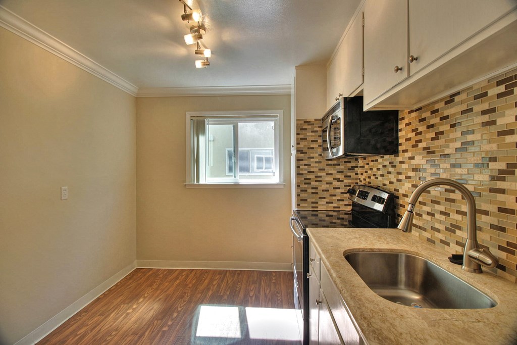 A kitchen with a sink and a window.