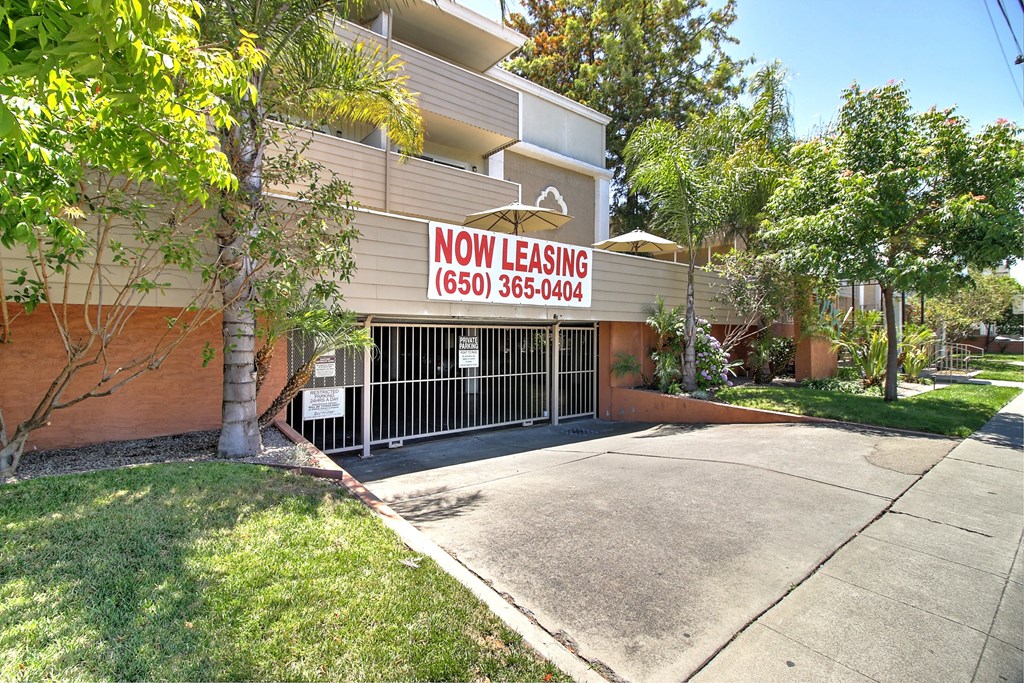 A building with a leasing sign on it.