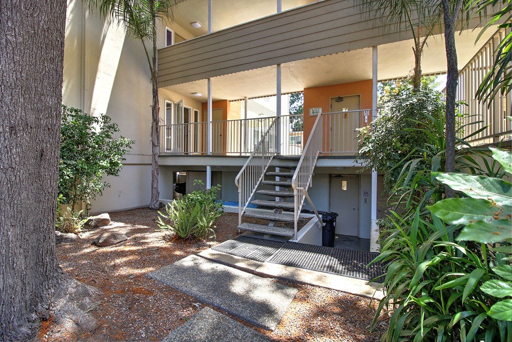 A house with a balcony and stairs leading to it.