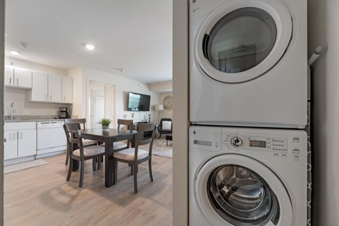 A modern laundry room with a washer and dryer stacked on top of each other.