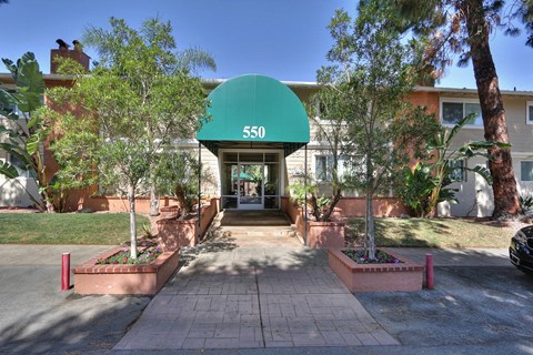 The entrance to apartment building 550 with a green awning.