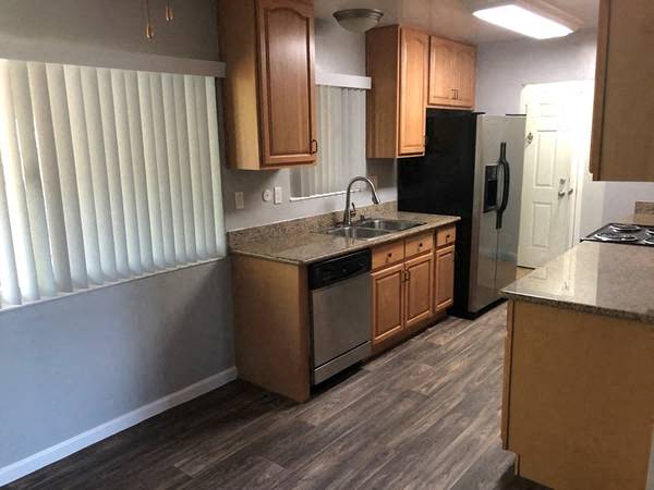 a kitchen with a sink and a refrigerator