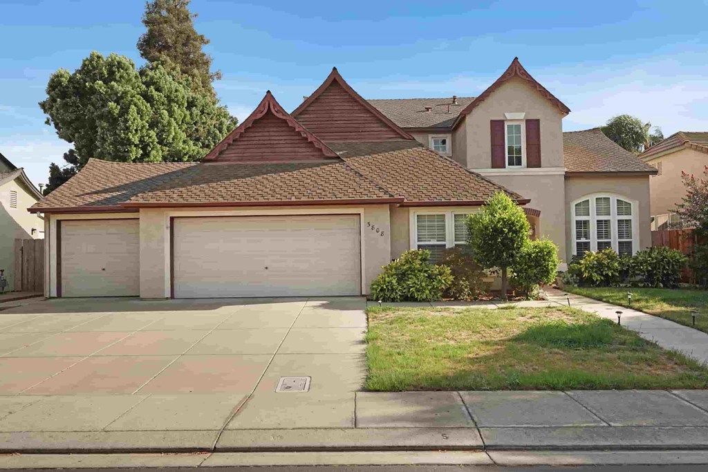 A house with a brown roof and a garage door.