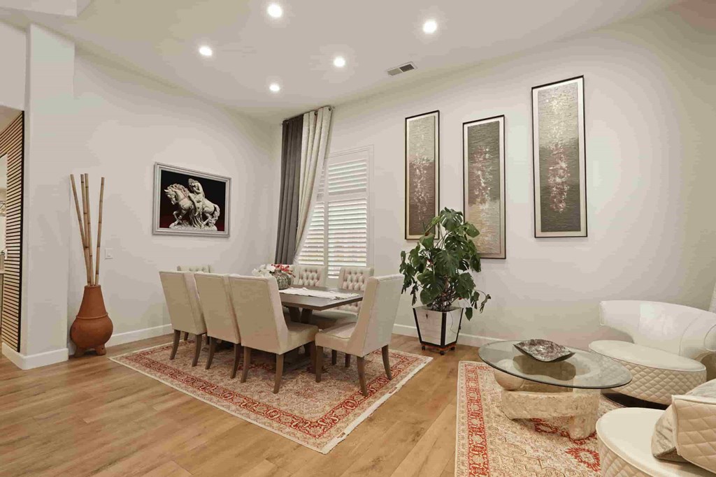 A living room with a dining table and chairs.