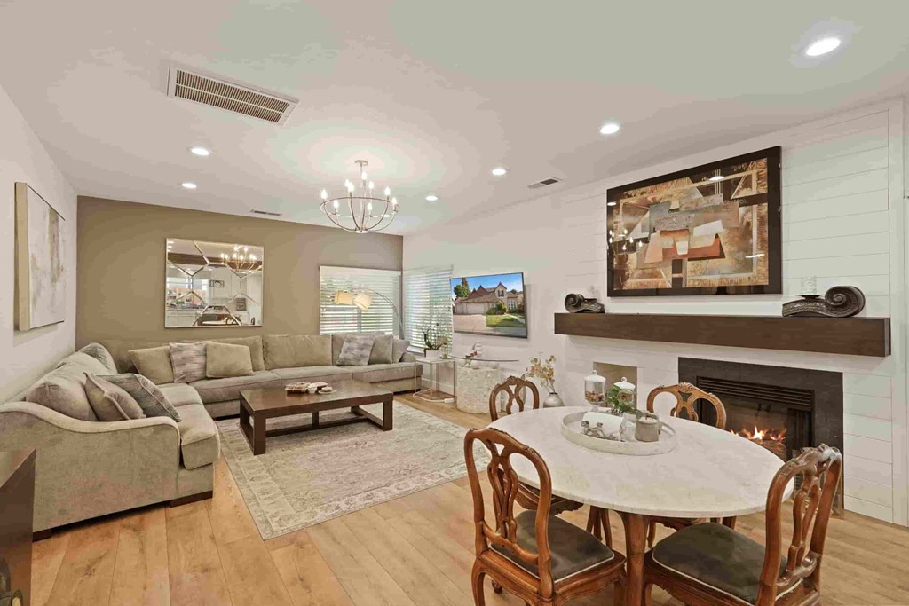 A living room with a fireplace and a television.