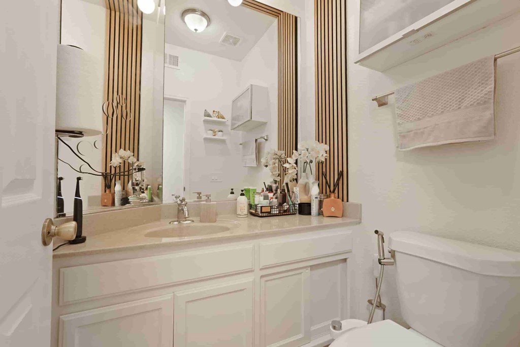 A bathroom with a white tub and sink.